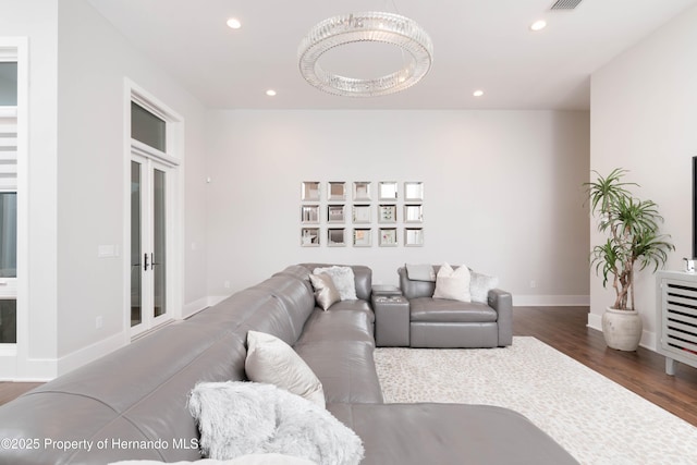 living room with baseboards, wood finished floors, and recessed lighting