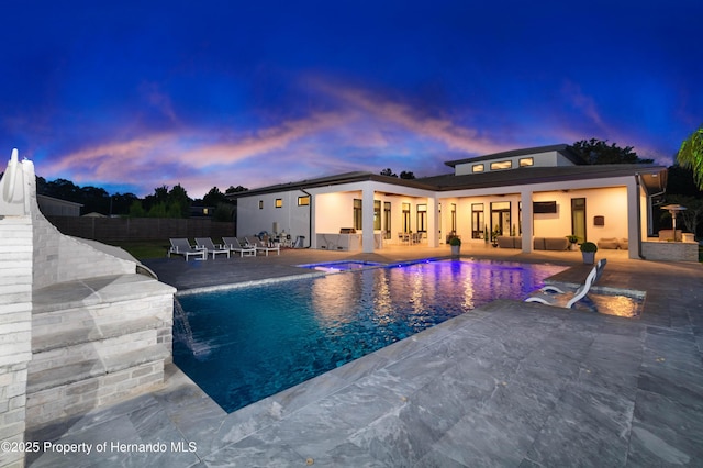 pool with fence, an outdoor hangout area, and a patio