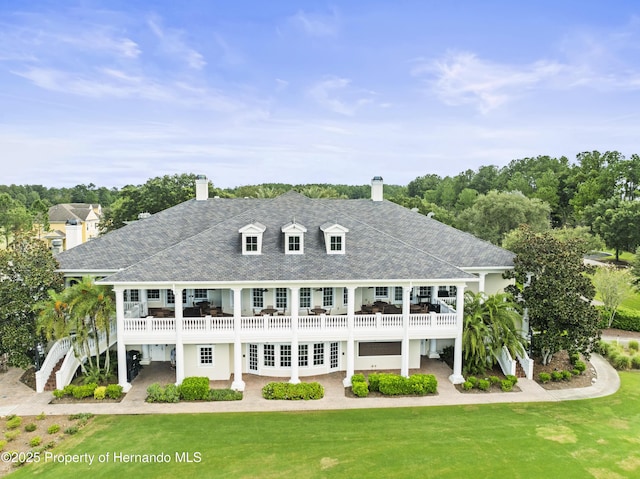 rear view of house with french doors, stairway, a lawn, and a patio area