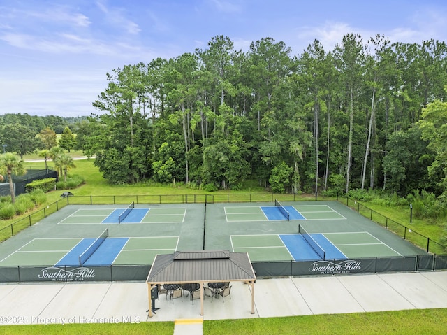 view of sport court featuring fence