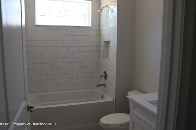 bathroom featuring toilet, vanity, and shower / bathtub combination