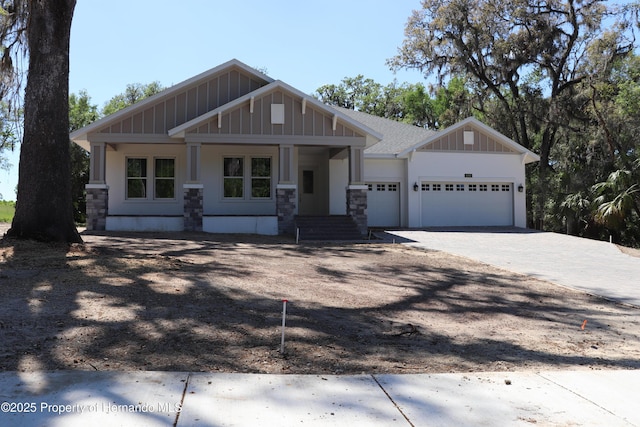 craftsman inspired home featuring driveway, a garage, and board and batten siding