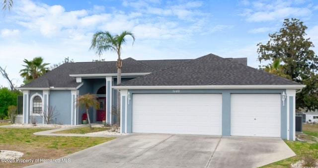 single story home with an attached garage, concrete driveway, and stucco siding