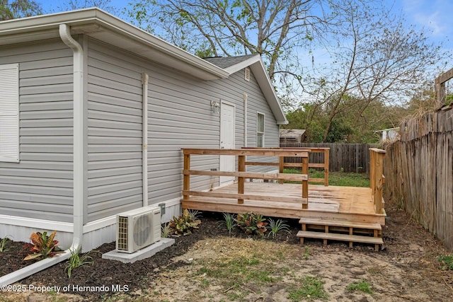 deck featuring ac unit and a fenced backyard