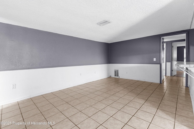 empty room featuring visible vents and a textured ceiling