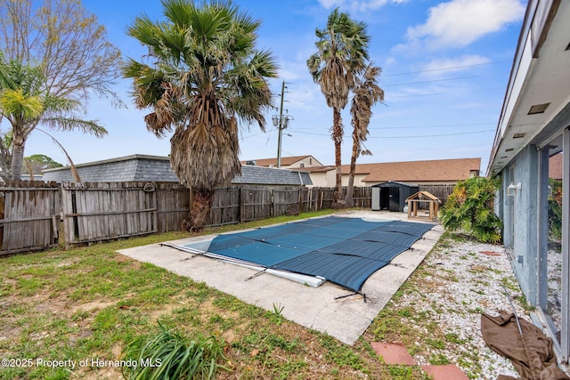 view of pool with a fenced in pool, an outdoor structure, and a fenced backyard