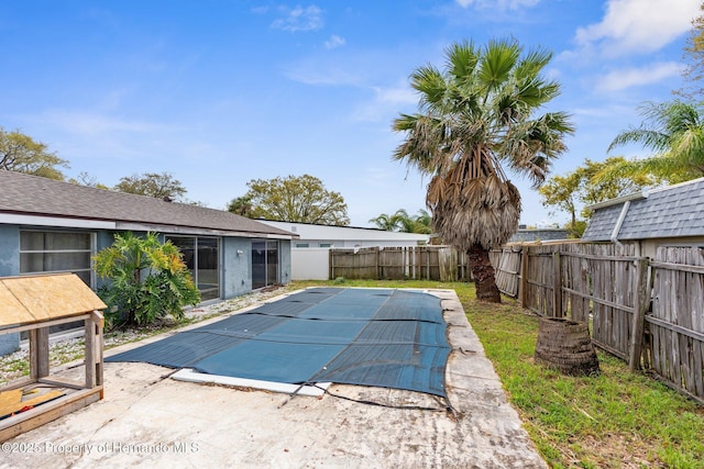 view of swimming pool featuring a patio and a fenced backyard