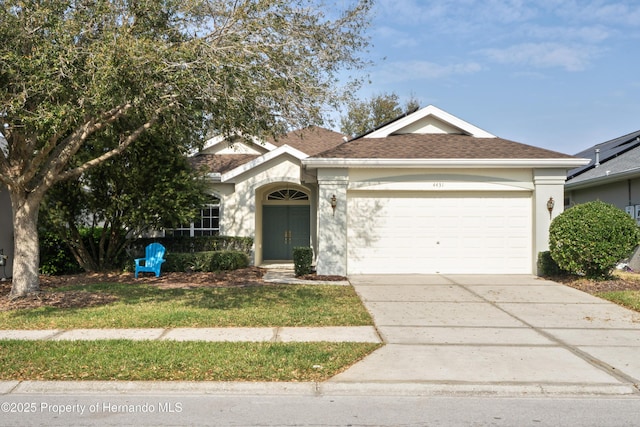 ranch-style home with stucco siding, driveway, an attached garage, and a shingled roof