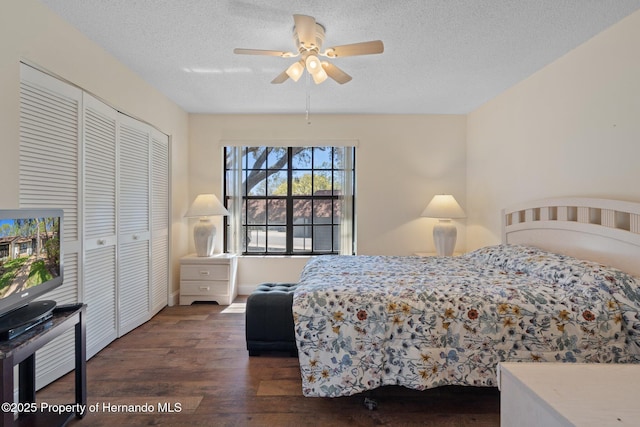 bedroom with a textured ceiling, ceiling fan, a closet, and wood finished floors