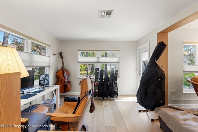 office featuring wood finished floors, visible vents, and baseboards