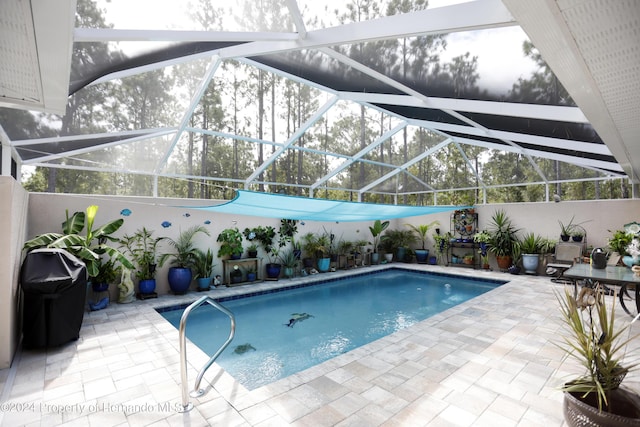 view of pool with a fenced in pool, glass enclosure, and a patio area