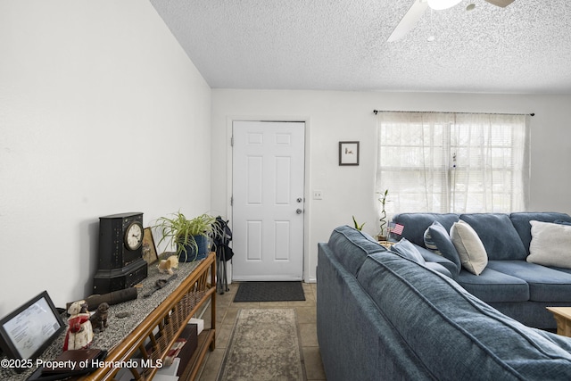 living area with a textured ceiling and a ceiling fan