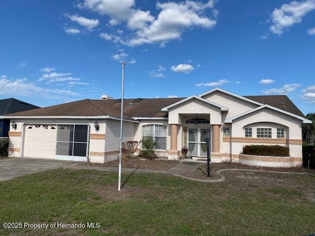 single story home featuring a garage, concrete driveway, a front yard, and stucco siding