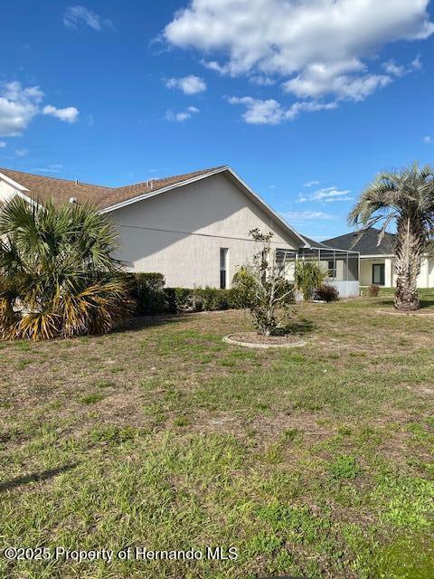 view of side of home with a lawn