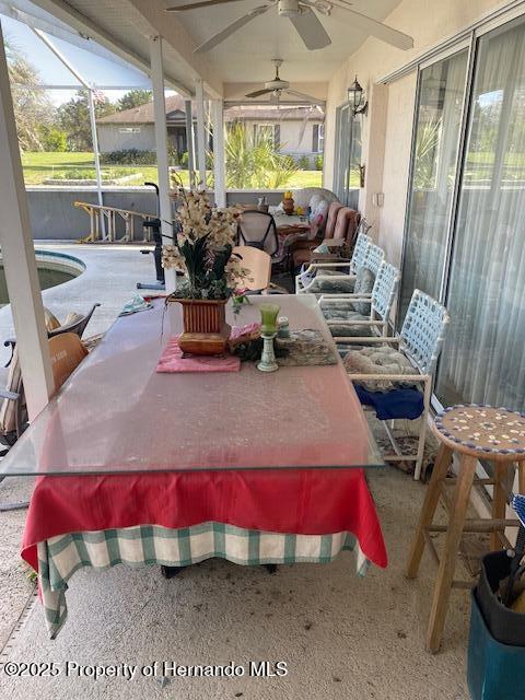 sunroom featuring ceiling fan