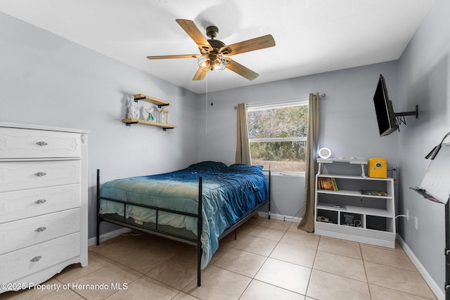 13415 Ester Dr, Brooksville, FL 34613 - tiled bedroom with baseboards and a ceiling fan
