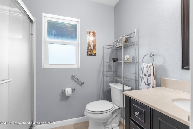13415 Ester Dr, Brooksville, FL 34613 - full bath with tile patterned floors, toilet, vanity, baseboards, and a shower