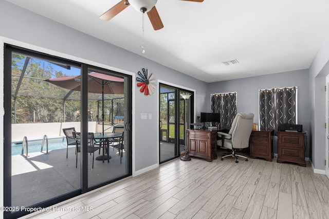 13415 Ester Dr, Brooksville, FL 34613 - office area with wood finished floors, visible vents, baseboards, and ceiling fan