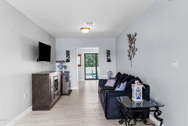 13415 Ester Dr, Brooksville, FL 34613 - living room with visible vents, light wood finished floors, and baseboards