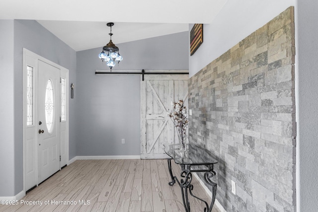 13415 Ester Dr, Brooksville, FL 34613 - foyer with a barn door, baseboards, and light wood-type flooring