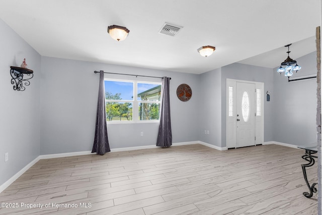 13415 Ester Dr, Brooksville, FL 34613 - foyer entrance with a chandelier, visible vents, baseboards, and a healthy amount of sunlight