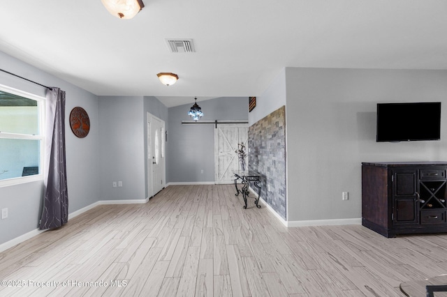 13415 Ester Dr, Brooksville, FL 34613 - unfurnished living room with baseboards, wood finished floors, and visible vents