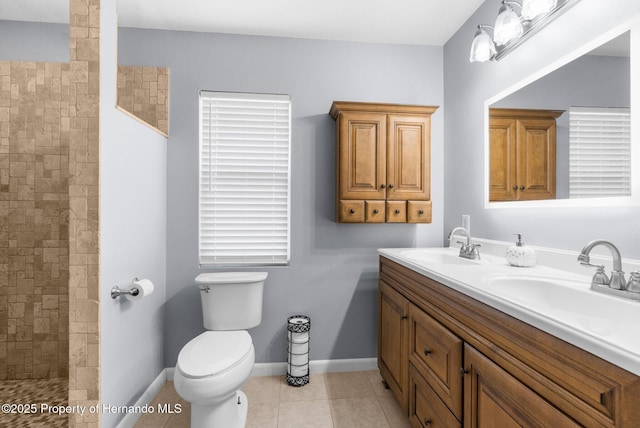 13415 Ester Dr, Brooksville, FL 34613 - bathroom with a tile shower, double vanity, toilet, and a sink