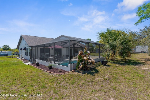 13415 Ester Dr, Brooksville, FL 34613 - back of house with a lawn, an outdoor pool, a patio, and glass enclosure