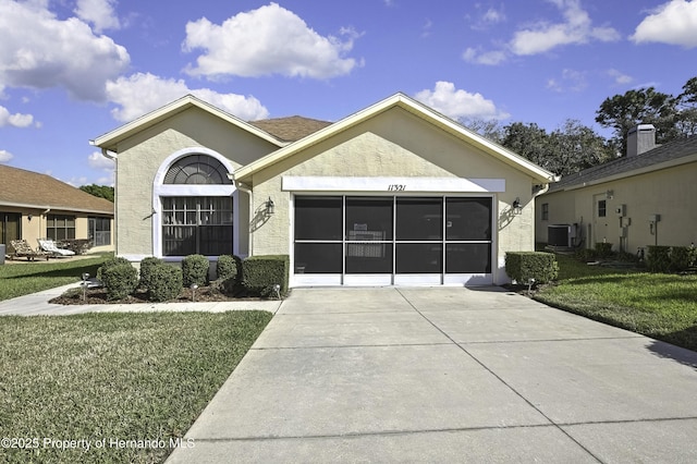 single story home featuring a garage, a front lawn, central air condition unit, and stucco siding