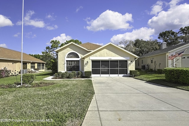 ranch-style house featuring stucco siding, central air condition unit, a garage, driveway, and a front lawn