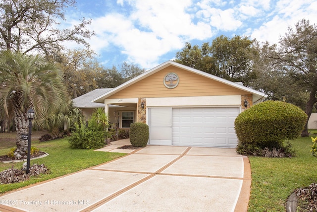 view of front of home featuring a garage, concrete driveway, and a front yard