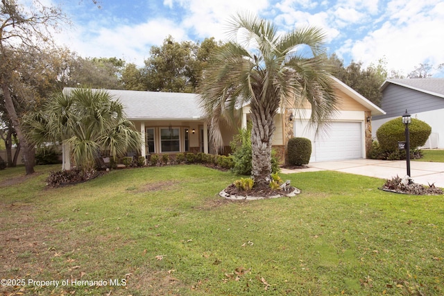 view of front of property with a garage, driveway, and a front yard