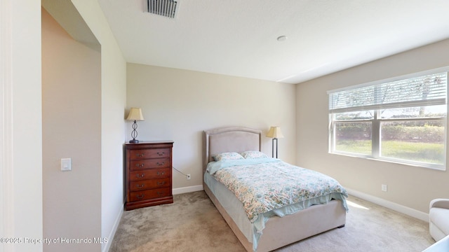 bedroom featuring carpet flooring, visible vents, and baseboards