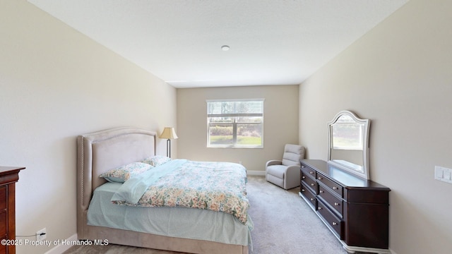 carpeted bedroom with baseboards