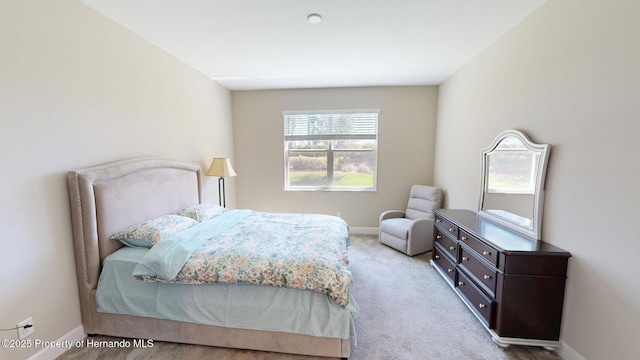 bedroom featuring carpet and baseboards