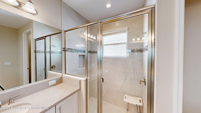 bathroom with a shower stall and vanity