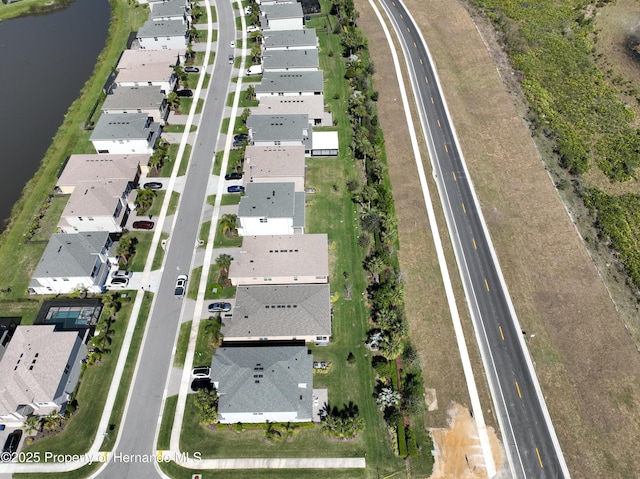 aerial view with a water view and a residential view