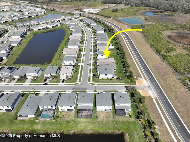 bird's eye view with a residential view and a water view