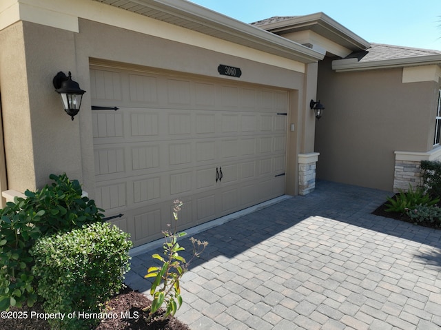 garage featuring decorative driveway