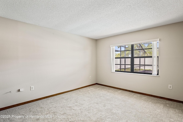 2013 Meredith Dr, Spring Hill, FL 34608 - carpeted empty room featuring a textured ceiling and baseboards