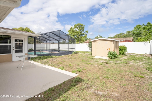 2013 Meredith Dr, Spring Hill, FL 34608 - view of yard featuring a storage unit, a patio area, an outdoor structure, and a lanai