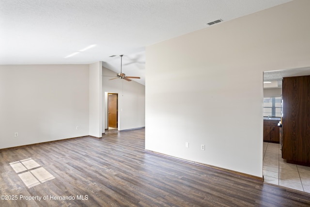 2013 Meredith Dr, Spring Hill, FL 34608 - spare room featuring wood finished floors, vaulted ceiling, a ceiling fan, and baseboards