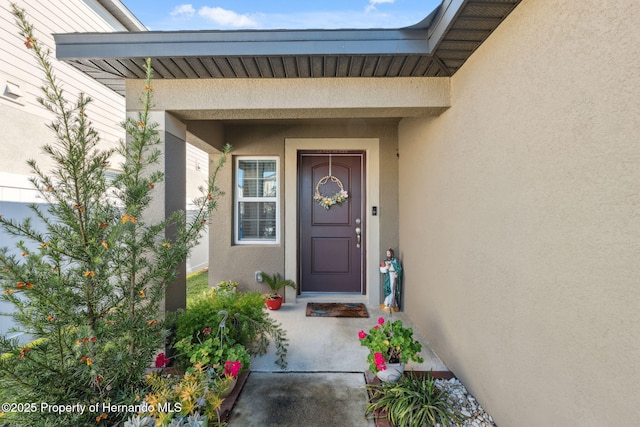 doorway to property with stucco siding