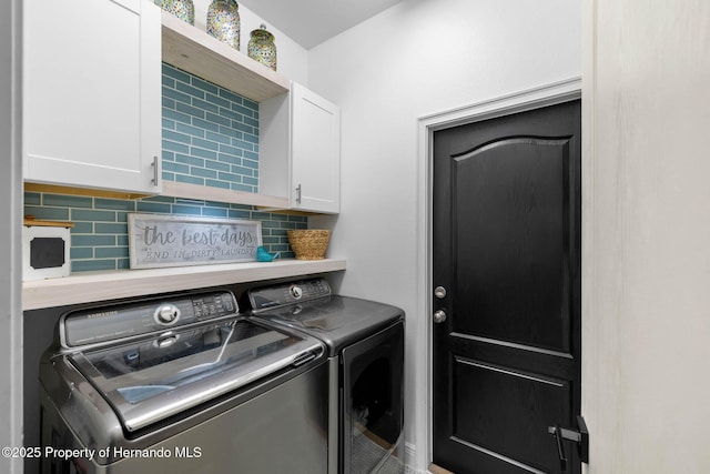 laundry area featuring cabinet space and washing machine and clothes dryer