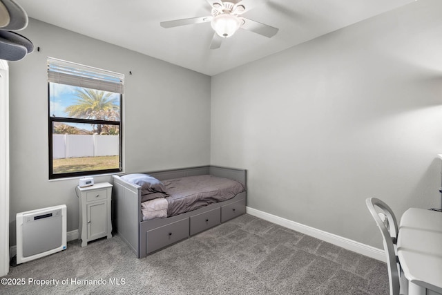 carpeted bedroom with a ceiling fan and baseboards