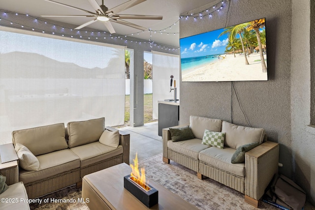 interior space with a ceiling fan and a textured wall