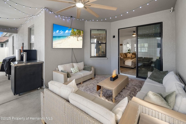 living area with ceiling fan