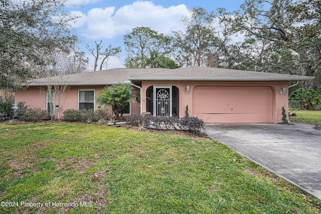 ranch-style home featuring a garage, driveway, a front lawn, and brick siding