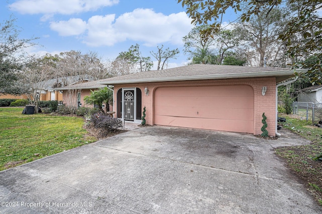 ranch-style house with a garage, concrete driveway, brick siding, and a front lawn