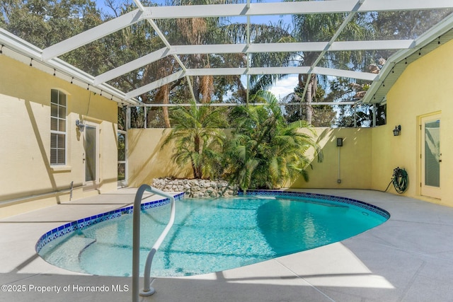 outdoor pool with a patio area and a lanai